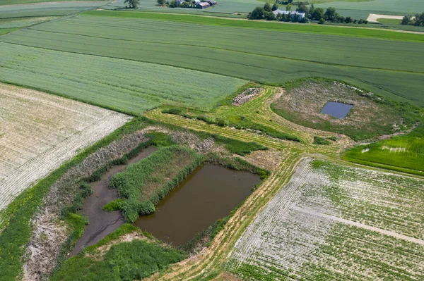 Early spring aerial landscape with fields of Poland. Typical polish landscape photographed from above. Aerial view of agricultural fields