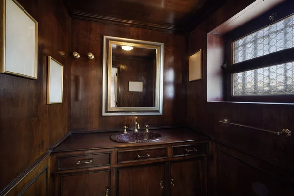 Home interior, vintage style bathroom with wooden walls.