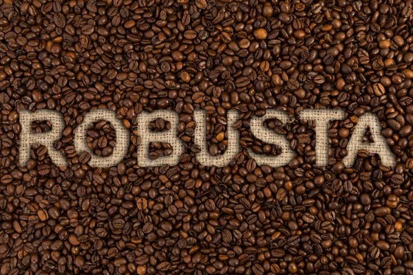 Conceito de robusta escrito em grãos de café — Fotografia de Stock