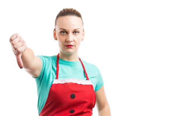 Housewife or housekeeper showing thumb down gesture — Stock Photo, Image