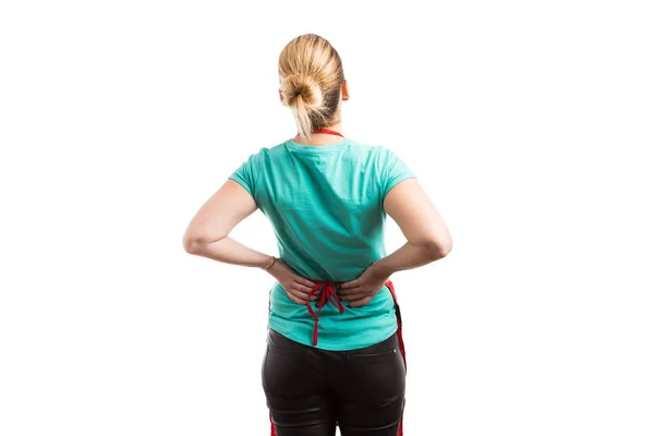 Tired housemaid or housekeeper suffering lower back pain — Stock Photo, Image