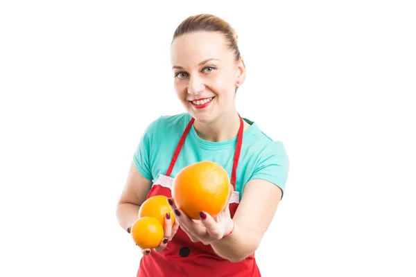 Hypermarket or supermarket employee holding fresh natural orange — Stock Photo, Image