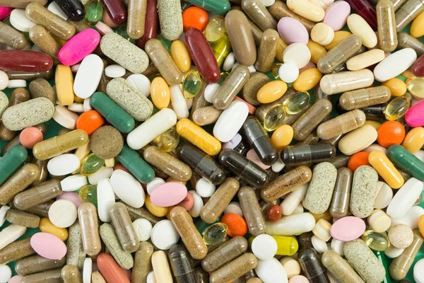 Imagen completa de muchas píldoras o tabletas al azar — Foto de Stock