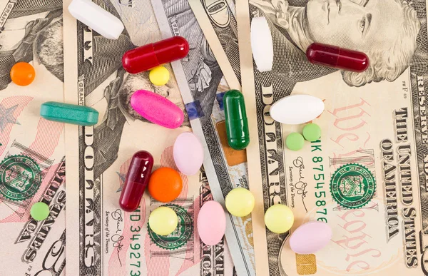 Pills and capsules on paper dollar bills