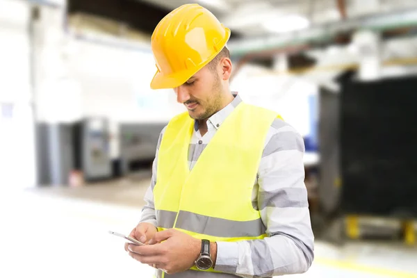 Factory worker employee chatting browsing texting on smartphon