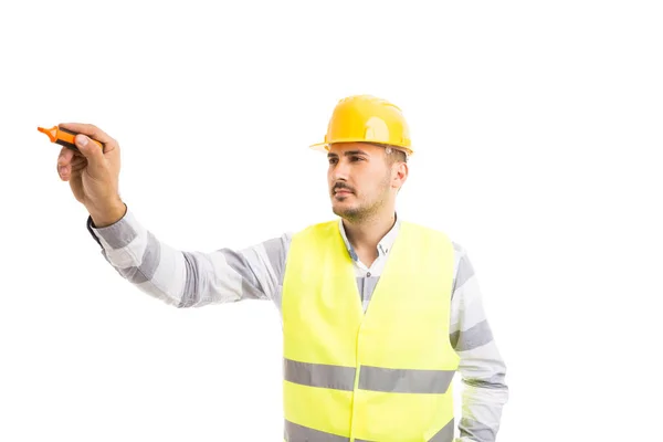 Handsome young architect holding and writing with marker pen — Stock Photo, Image