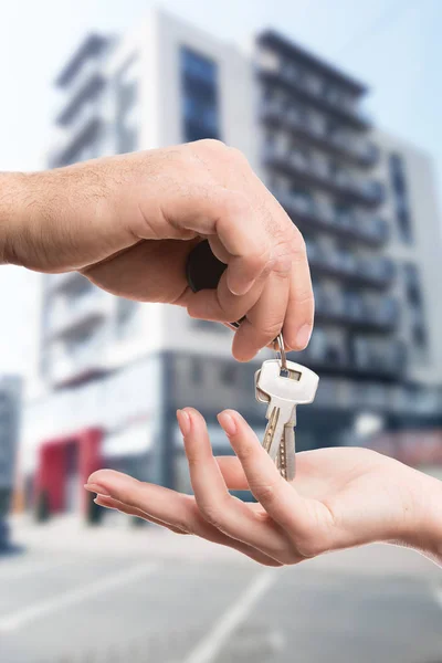 Close-up of realtor hand giving key