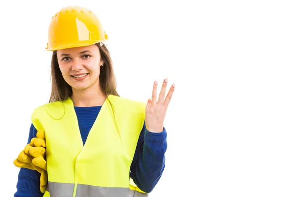 Young woman constructor showing number thre — Stock Photo, Image