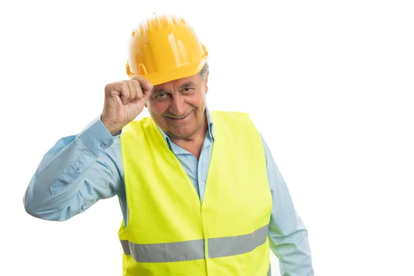 Builder touching helmet — Stock Photo, Image