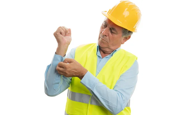 Construction worker buttoning sleeve Stock Photo