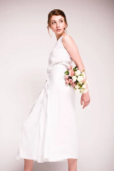 Girl in white dress with flowers — Stock Photo, Image