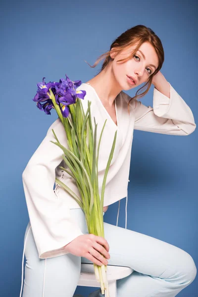 Beautiful woman with iris flowers — Stock Photo, Image