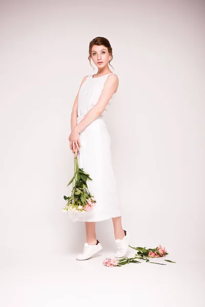 Mädchen im weißen Kleid mit Blumen — Stockfoto