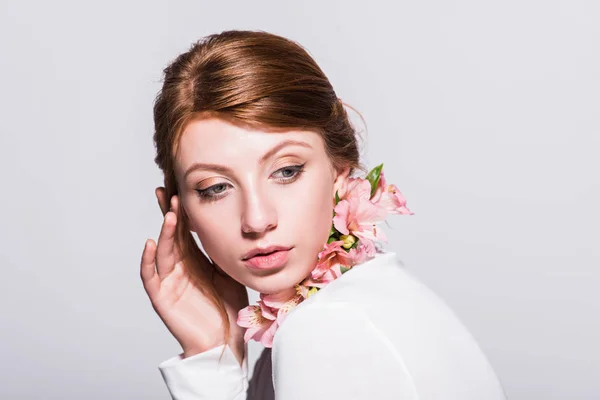 Attractive girl with lilies — Stock Photo