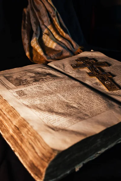 Old Russian orthodox bible on the table  with a gold cross