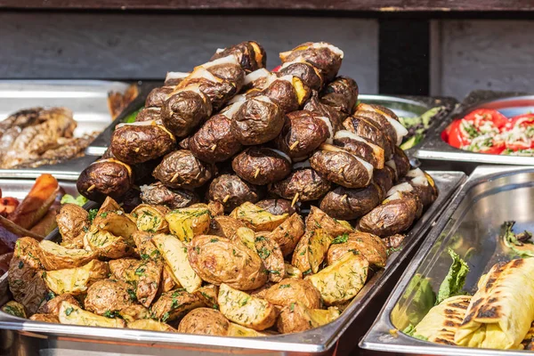 Culinary Buffet with healthy take away meal - grilled vegetables, fish and meat on the street food culinary market, festival, event.  Different types of delicious meat. Outdoor Cuisine. Street fair stand.