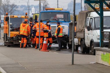Kyiv Ukrayna - 28 Mart 2020: İşçiler COVID-19, Coronavirus romanının yayılmasına karşı önleyici tedbirler kapsamında dezenfektan püskürtüyor. Coronavirüs 'e karşı dezenfekte.