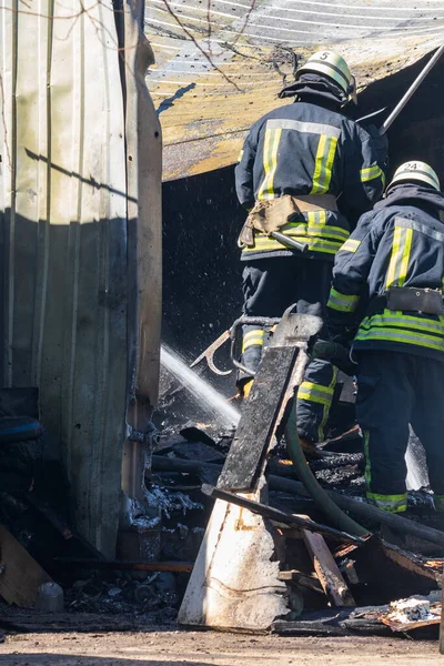 Strong Brave Fireman Rescues Burning Building Using Water Fire Operation Royalty Free Stock Photos