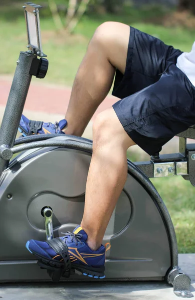 Close Up Asian Man Riding On Stationary Exercise Bike For Healthy In Public Park — Stock Photo, Image