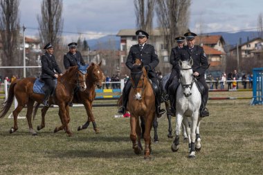 Sofia, Bulgaria - March 03, 2020: Equestrian Easter or Todor Day in Bulgaria, policemen riding horses on the holiday. Jumping on horseback.