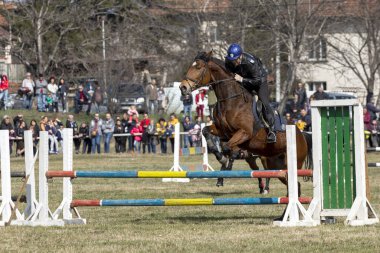 Sofia, Bulgaria - March 03, 2020: Equestrian Easter or Todor Day in Bulgaria, policemen riding horses on the holiday. Jumping on horseback.