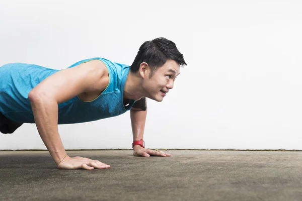 Asian man stretching during exercising