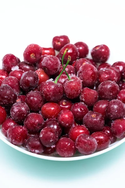 Group of frozen cherries on a white background . close-up of berries. ice crystals on the fruit. vertical photo top view — Stock Photo, Image