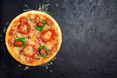 Arka planda vejetaryen pizzası için malzemeler. biber, kiraz domatesleri, mantarlar, otlar, peynir. Yukarıdan manzara, fotoğraf çekmek için bir yer. Vejetaryen. Sağlıklı yemek için yuvarlak pizza.