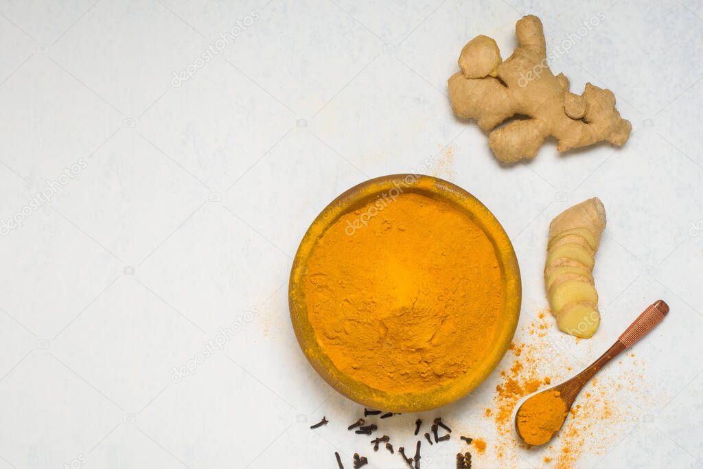 ingredients for Indian traditional Golden milk with turmeric, ginger, spices, honey. healing effect of the drink. antiviral therapeutic antioxidant.