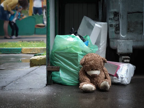 Teddy bear thrown in the trash like garbage