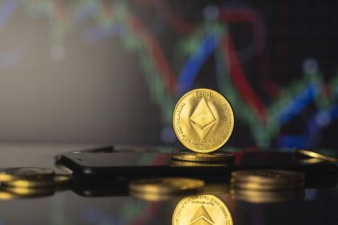 Ethereum ve sanal para kavramı. Bir kripto para biriminin büyüyen ve düşen değerinin grafiğiyle altın bir ethereum yığını. Madencilik ya da engelleme teknolojisi.