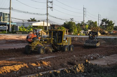 VİETNAM, HO CHI MINH - 15 Mayıs 2019: Grader yol inşaatında çalışıyor. Sınıf endüstriyel makine yeni yollar inşa ediyor. Otoyolda çalışan ağır iş makineleri.
