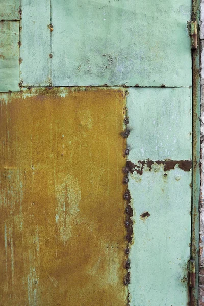 Green painted metal rusted background. Metal rust texture. Erosion metal. Scratched and dirty texture on outdoor rusted metal wall.