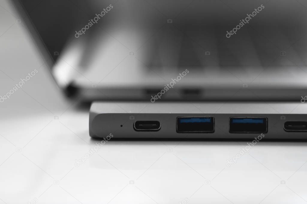 The USB adapter under the Type-C connector for laptop. Multiport station for laptop with multiple different ports. USB to USB Type-C Hub Converter. Gadgets for use a modern laptop.