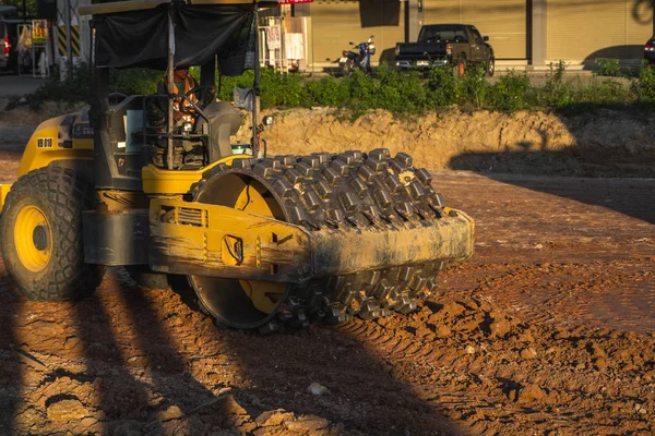 VIETNAM, HO CHI MINH - May 15, 2019: Soil compactor with vibratory padfoot drum. Heavy duty machinery working on highway construction site. Vehicle for soil compaction. — Stock Photo, Image