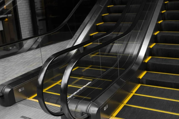 Empty escalators stairway with a yellow stripes. — Stock Photo, Image