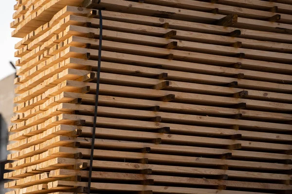 Warehouse for sawing boards on a sawmill outdoors. Timber mill, sawmill. Storage of planed wooden boards. Piles of wooden boards in the sawmill. Planking. Industry. — Stock Image Warehouse for sawing boards on a sawmill outdoors. Timber mill, sawmill. Storage of planed wooden boards. Piles of wooden boards in the sawmill. Planking. Industry. Royalty Free Stock Photos