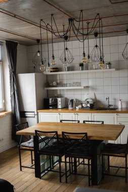 Lüks bir evde paslanmaz çelik aletlerle modern, parlak, temiz bir mutfak. Lüks malikanedeki mutfak. Modern mimari çağdaş, iç mimari. Şık mutfaklar. İçi masalarla dolu..