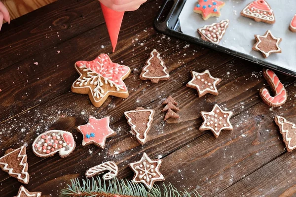 ginger biscuit and christmas decoration on dark wood background. soft light.