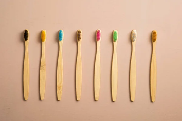 Set of colorful bamboo toothbrushes on brown background. Zero waste, plastic free concept. Flat lay, top view. — 스톡 사진