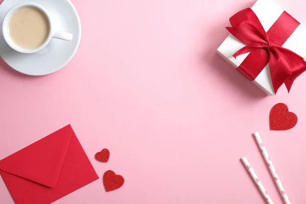 Happy Valentine's day concept. Flat lay composition with coffee cup, red paper envelope, gift box, Valentines hearts on pink background. Top view with copy space. — 스톡 사진