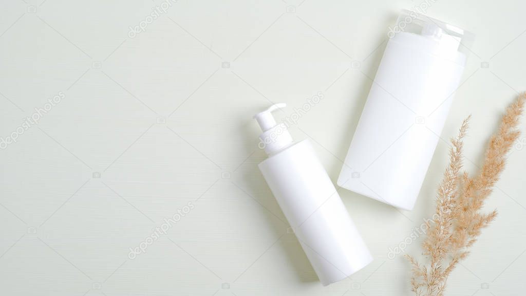 Natural cosmetics SPA branding mockup. Clear shampoo bottle and lotion packaging with dried flower. Beauty cosmetic product, skincare, body care concept