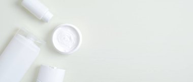 Spa kozmetik ürünleri markalaştırma modeli. Şampuan ve duş jeli için boş şişeler, gerekli yağ paketi, yüz kremli kavanoz. Minimalist tarzda dümdüz yatıyordu. Güzellik ürünleri konsepti