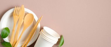 Eko mağaza afişi tasarımı. Çevre dostu ahşap çatal bıçak seti, kağıt bardak ve kahverengi yapraklı tabak. Sıfır atık, plastiksiz konsept. Sürdürülebilir yaşam tarzı.