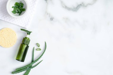 Üst manzara aloe vera jeli ve mermer zemin üzerinde dilimlenmiş bitki yaprakları. Doğal organik SPA kozmetik ürünü. Cilt bakımı, kozmetoloji, cilt bakımı.