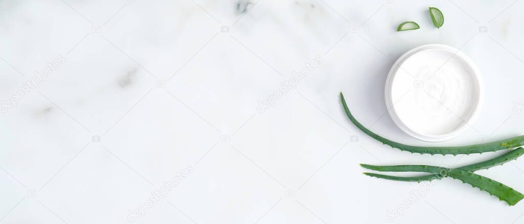 Aloe vera cream on marble background. Natural organic cosmetic product, facial treatment, body or hair skin care concept