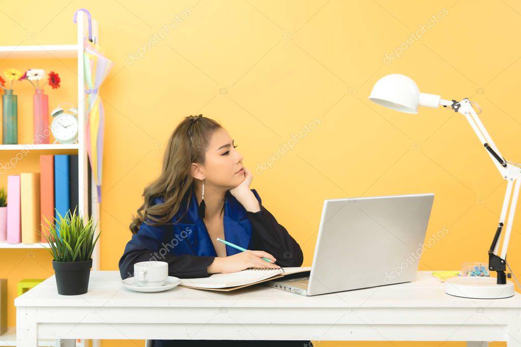 Cheerful business lady working on laptop in office