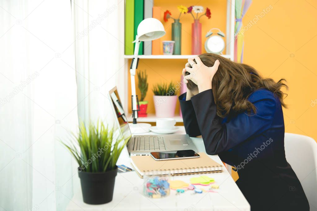 Young beautiful woman having headache working on computer at hom