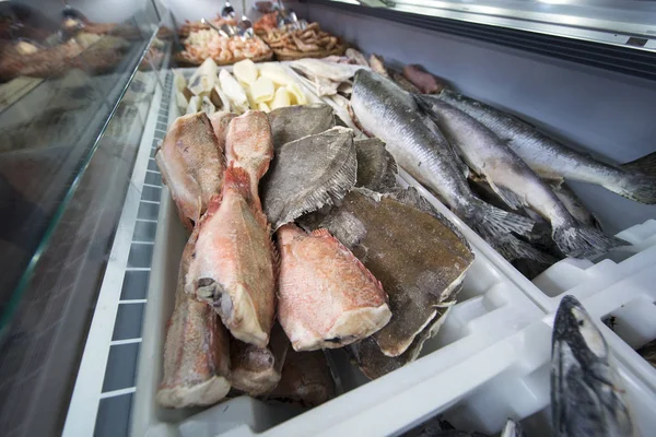 Close up of frozen seafood fish in white crates in store