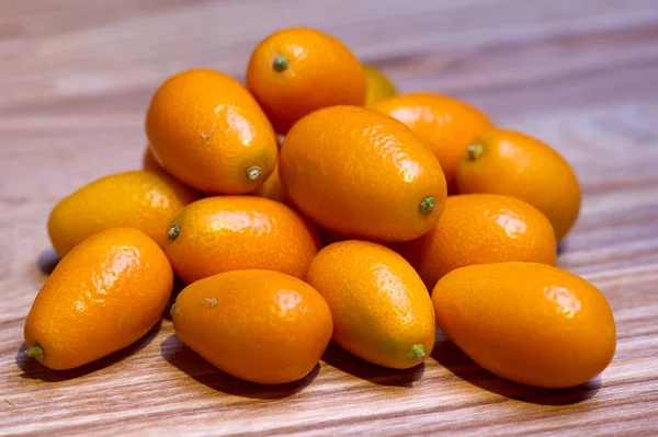 Exotic Kumquat Fruit Wooden Desk — Stock Photo, Image